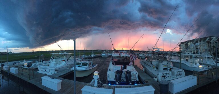 Fishing boats tied up at the docks in Murrells Inlet, South Carolina, under dramatic evening storm clouds