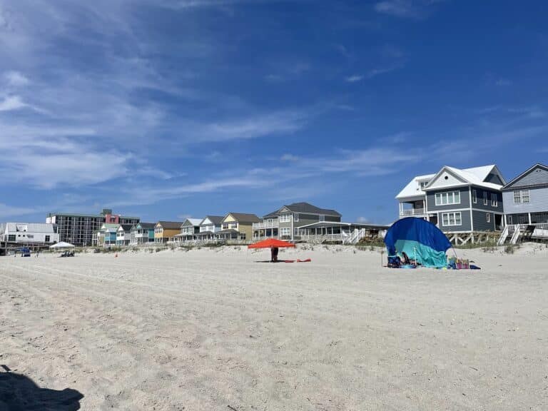 Wide sandy beach lined with colorful beach houses on the South Carolina coast near Garden City Beach