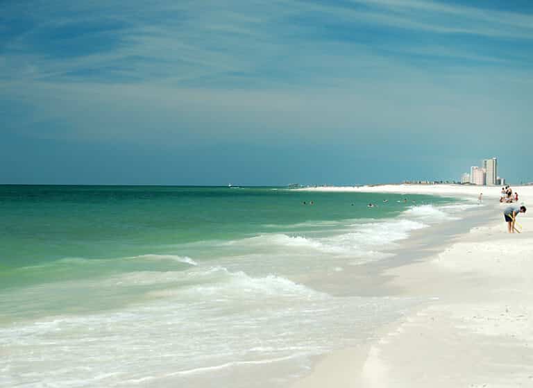 Calm turquoise water and white sand on a sunny morning at Gulf State Park, Gulf Shores, Alabama