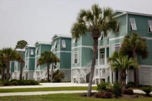 Row of raised beach houses with palm trees in the beach community of Gulf Shores, Alabama