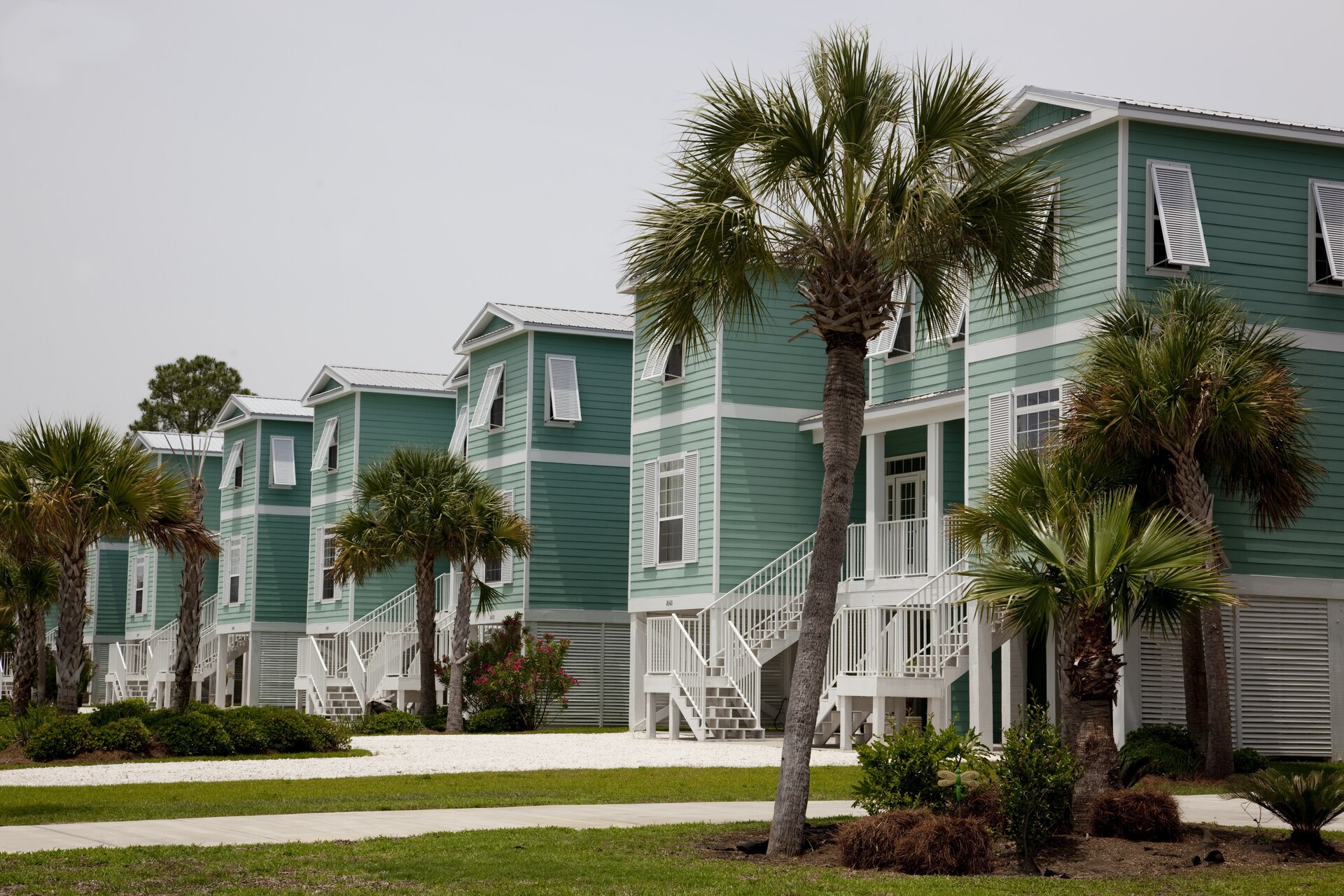 Row of raised beach houses with palm trees in the beach community of Gulf Shores, Alabama